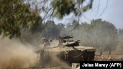 An Israeli army tank maneuvers during a military exercise simulating conflict with Lebanese movement Hezbollah, in the Israeli annexed Golan Heights, near the Syrian border, September 5, 2017