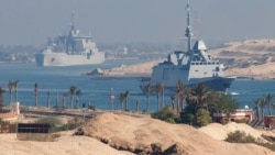A French Navy carrier strike group and its escort transit the Suez Canal en route to the southern Red Sea.