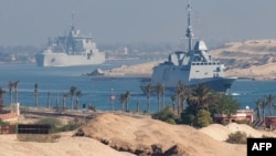 A French Navy carrier strike group and its escort transit the Suez Canal en route to the southern Red Sea.