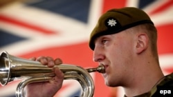 FILE: A bugler from the Royal Anglian Regiment plays members of the British Armed Forces take part in a service of commemoration taking place at the Afghan National Army Officers Academy (ANAOA) in Kabul.