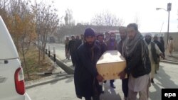 People carry the coffin of a victim of a suicide bomb attack that targeted a volley ball match, in Paktika, November 24, 2014