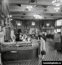 A customer peruses the shop's meat-and-cheese section in 1950.