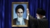 Iran -- Iran's Supreme Leader Ali Khamenei before a portrait of his predecessor Ayatollah Ruhollah Khomeini, undated.