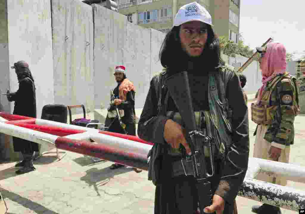 Taliban fighters stand guard at a checkpoint that was previously manned by U.S. troops near the U.S. Embassy in Kabul on August 17.