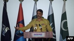 Pakistani Army spokesman Major General Asif Ghafoor speaks with media representatives as he gives details of a captured would-be female suicide bomber Noreen Leghari during a press conference in Rawalpindi on April 17.