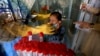 A young girl reacts while having a nasal swab sample taken by a health worker at a COVID-19 testing facility at a hospital in Karachi on March 18.