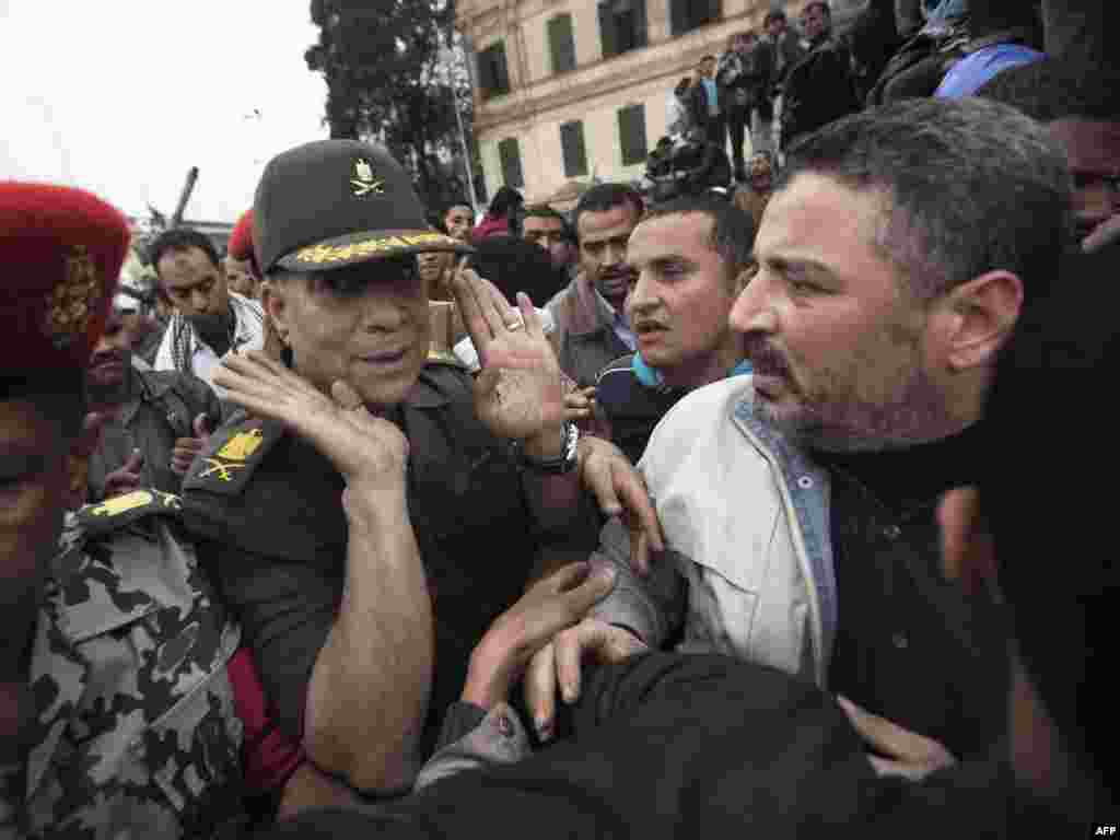 General Hassan el-Roweni argues with anti-Mubarak demonstrators as he tries to convince them to dismantle barricades.