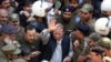 Police escort former Pakistani prime minister Nawaz Sharif (C) as he leaves the accountability court in the eastern city of Lahore in October 2019.