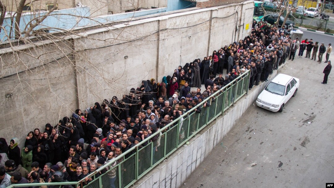 Iranians line up to receive food supplies in southern Tehran. Three people reportedly died while waiting in line in freezing temperatures, and hard-liners have alleged that the sight of citizens lining up for handouts is damaging to Iran's image abroad.