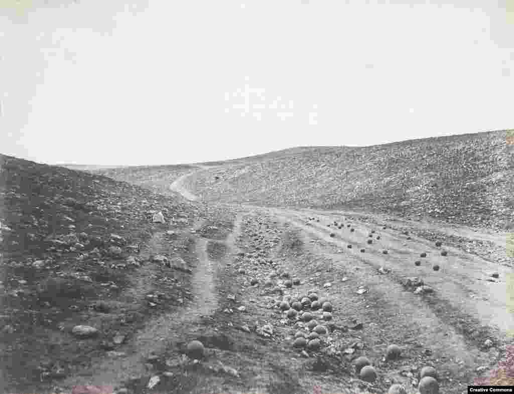 Cannonballs dot the landscape in Crimea after a battle. In Crimea, Tolstoy described watching amputations being &nbsp;carried out on his fellow soldiers -- an experience that profoundly shifted his views on war: &quot;You see the sharp, curved knife enter the healthy, white body,&quot; he wrote later. &quot;You see the wounded man suddenly regain consciousness with a piercing cry and curses, you see the army surgeon fling the amputated arm into a corner, you see another wounded man, lying in a litter in the same apartment, shrink convulsively and groan as he gazes at the operation upon his comrade...you behold war, not from its conventional, beautiful, and brilliant side, with music and drumbeat, with&nbsp;fluttering flags and galloping generals, but you behold war in its real phase -- in blood, in suffering, in death.&quot;