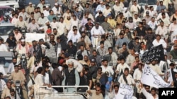 Pakistani traders march during a rally in Karachi against political killings on October 27. A recent study says cities are a good way to measure human development.