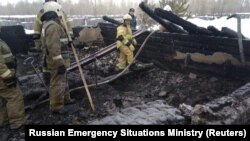 Russian Emergencies Ministry members work at the site of the fire on January 21.