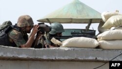 Pakistani soldiers take position at post in North Waziristan in a file photo.