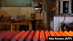 FILE - An employee works at the Iran Alloy Steel Company (IASCO)'s plant in the central Iranian city of Yazd, April 6, 2015