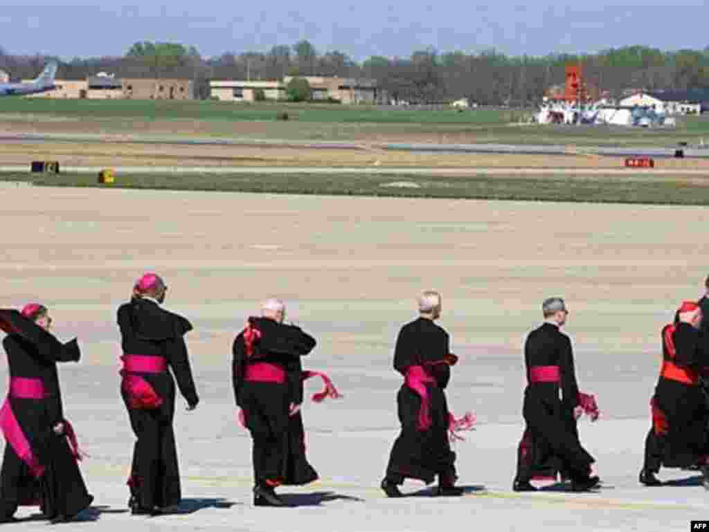 U.S. Roman Catholic officials greet Pope Benedict XVI upon his arrival in the United States. - Roman Catholic officials are escorted on the tarmac to meet Pope Benedict XVI upon his arrival at Andrews Air Force Base, Maryland, April 15, 2008 as the Pope starts his six-day visit to Washington and New York.