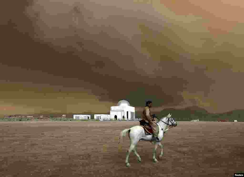 A man rides a horse at a playground on a hill in Kabul. (Reuters/Mohammad Ismail)