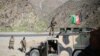 FILE: Afghan army soldiers stand guard on a roadside.