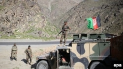 FILE: Afghan army soldiers stand guard on a roadside.