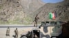 Afghan army soldiers stand guard on a roadside in Kabul in April.