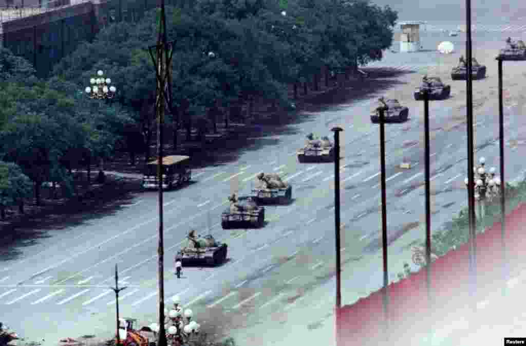 An unarmed man stands in front of a column of tanks on the Avenue of Eternal Peace on June 5. The tanks moved around him. The man's identity has not been confirmed and little is known about his fate after the standoff.