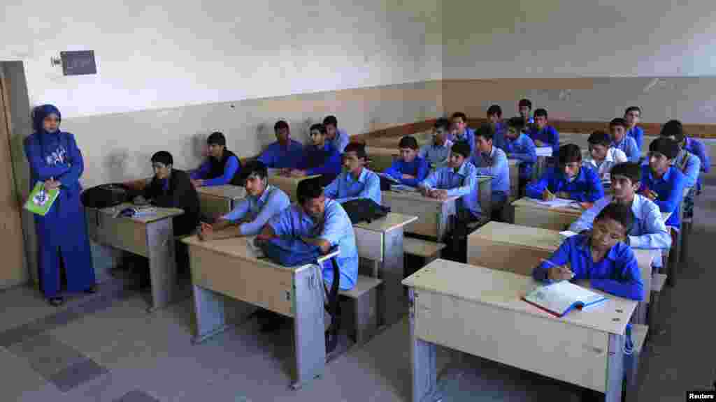 Students listen to their teacher at Habibia High School in Kabul.
