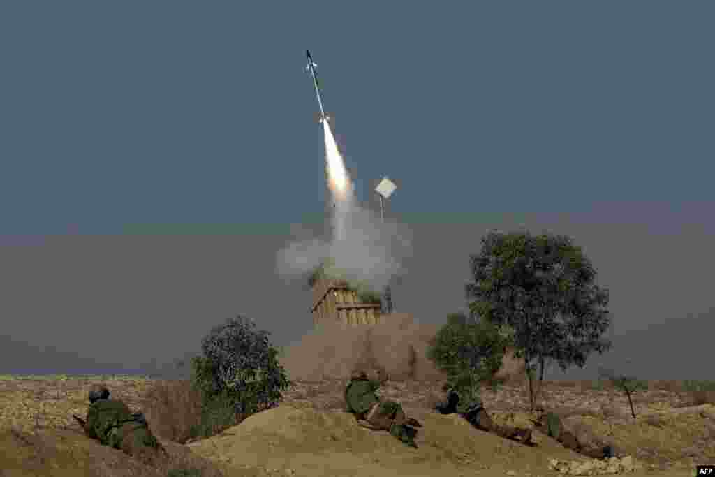 The Israeli military launches a missile from the Iron Dome missile system in the southern Israeli city of Beer Sheva into the Gaza Strip. The UN Security Council held a late-night emergency meeting on the escalating tensions after Israel carried out more than 20 air strikes and sea artillery attacks on Gaza, killing the military commander for Hamas. (AFP/Menahem Kahana)