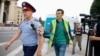 Radio Azattyq reporter Manas Kayirtauly tries to get a comment from a police officer in Almaty in 2019.