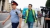 Manas Qaiyrtaiuly, a reporter for RFE/RL's Kazakh Service, attempts to speak to a police officer in Almaty in June 2019.