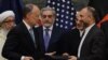 Afghan National Security Adviser Hanif Atmar (R) and US Ambassador to Afghanistan James Cunningham (2L) hold their documents after signing a deal September, 2014.