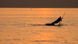 HUNGARY A person paddles an SUP Board during sunset at the Lake Balaton in Fonyod, July 27, 2021