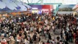 Passengers wait to be checked-in manually at Kuala Lumpur International Airport amid global IT outage, in Sepang