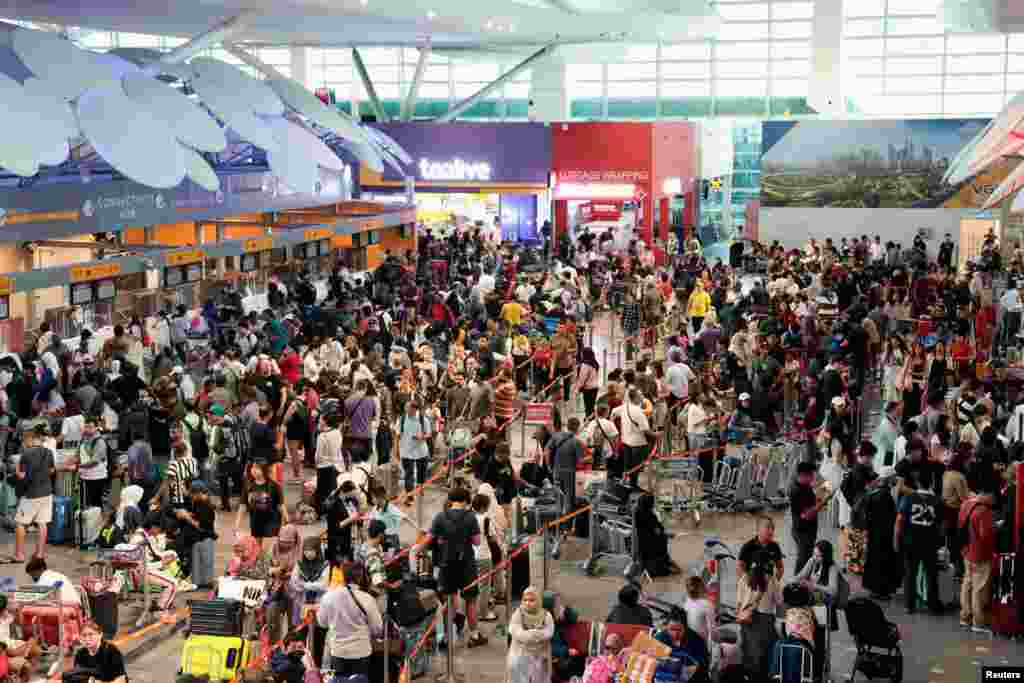 Passengers wait to be checked in manually at Kuala Lumpur International Airport amid a global IT outage in Sepang. A software update by&nbsp;global cybersecurity firm&nbsp;CrowdStrike appeared to have triggered system problems that grounded flights, forced some broadcasters off the air, and left customers without access to services such as health care or banking.