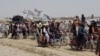 Pakistani supporters of the Taliban fly the Islamist group's signature white flags in the Afghan-Pakistan border town of Chaman on July 14.