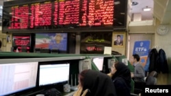 Stock market employees work at Tehran's Stock Exchange. FILE PHOTO