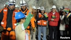 Bolivian national Carlos Mamani celebrates as he arrives as the fourth miner to be hoisted to the surface in Copiapo on October 13.