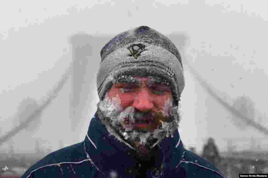 A man walks through blinding snow across the Brooklyn Bridge during Storm Grayson in New York City on January 4. (Reuters/Darren Ornitz)