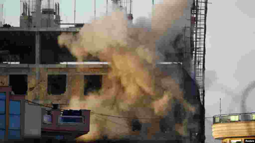 An explosion at a construction site during one of the running battles in Kabul early on April 16. (REUTERS/Omar Sobhani)