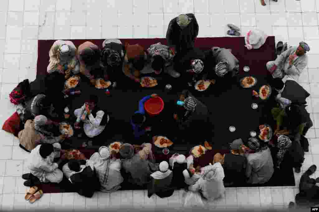 Afghan men break their fast during the holy month of Ramadan at the Hazrat-e Ali shrine in Mazar-e Sharif. (AFP/Farshad Usyan)