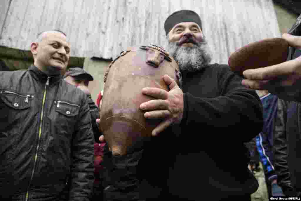 The ball weighs 18 kilograms. As the locals add the filling to the ball, the priest blesses the players.