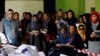 Election observers watch the counting of ballots during parliamentary elections at a polling station in Kabul on October 21.