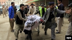 A man who was injured in a bomb blast is rushed to a hospital in Peshawar on March 16.