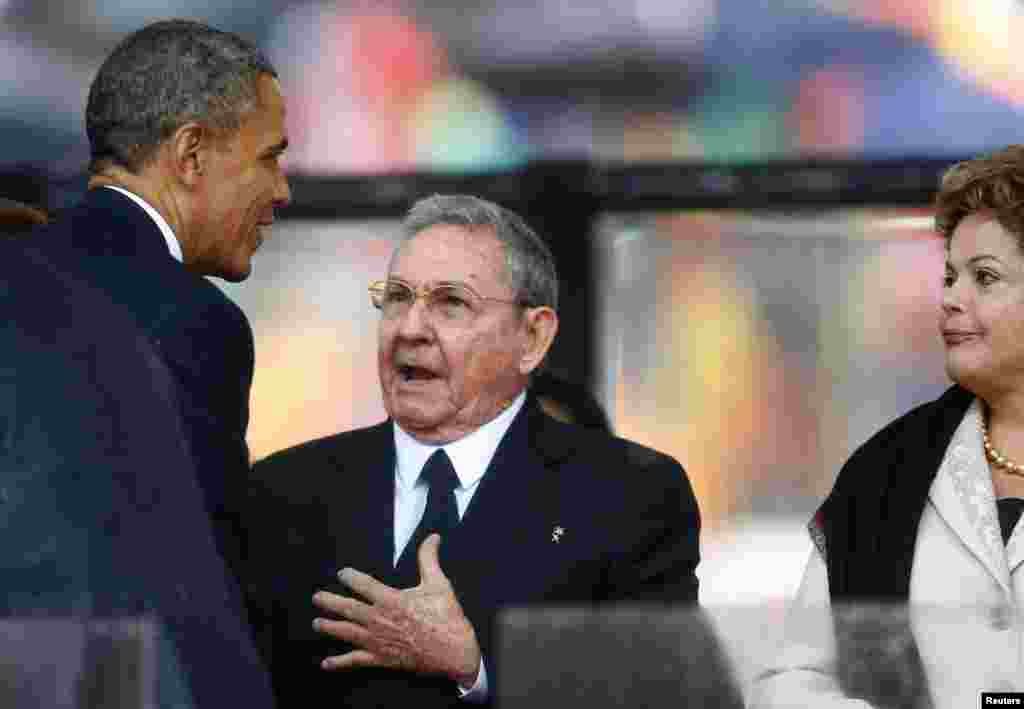 U.S. President Barack Obama greets Cuban President Raul Castro before delivering a speech.