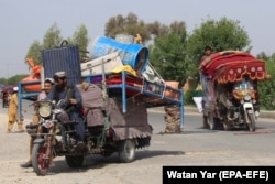 People displaced from their homes due to fighting flee Helmand Province on May 25.