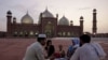 A Pakistani family waits to break their fast in the compound of the Mughal-era Shahi Mosque on August 3.