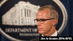 Acting FBI Director Andrew McCabe speaks at a press conference to announce the results from the Justice Department's annual national health-care-fraud takedown at the Department of Justice in Washington in July 2017.