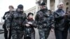 Protesters are detained at a demonstration in front of KGB headquarters in Minsk "to support arrested patriots" on March 31.