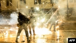 Protesters shoot fireworks toward police during a fourth day of nationwide protests against a government decision to shelve EU membership talks in Tbilisi early on December 2.