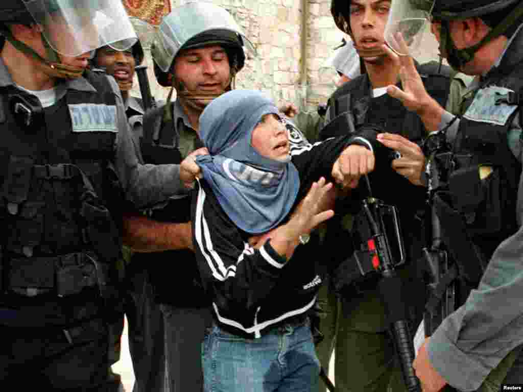 A young Palestinian protester is arrested by Israeli border police in Jerusalem's Old City, April 6, 2001 after clashes broke out following Friday's Muslim prayers. As Israel prepared for the weeklong Passover holiday, commemorating the biblical exodus of the Israelites from Egyptian slavery, the militant Islamic Jihad group vowed to avenge the killing of one of its West Bank leaders. REUTERS /Evelyn Hockstein 