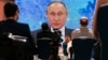 Russian President Vladimir Putin speaks via video call during his annual news conference in Moscow on December 17.