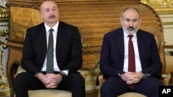 Azerbaijani President Ilham Aliyev (left) and Armenian Prime Minister Nikol Pashinian. "This is an issue between our two countries, and we have to solve it ourselves," the Azerbaijani president said in a January 10 interview.